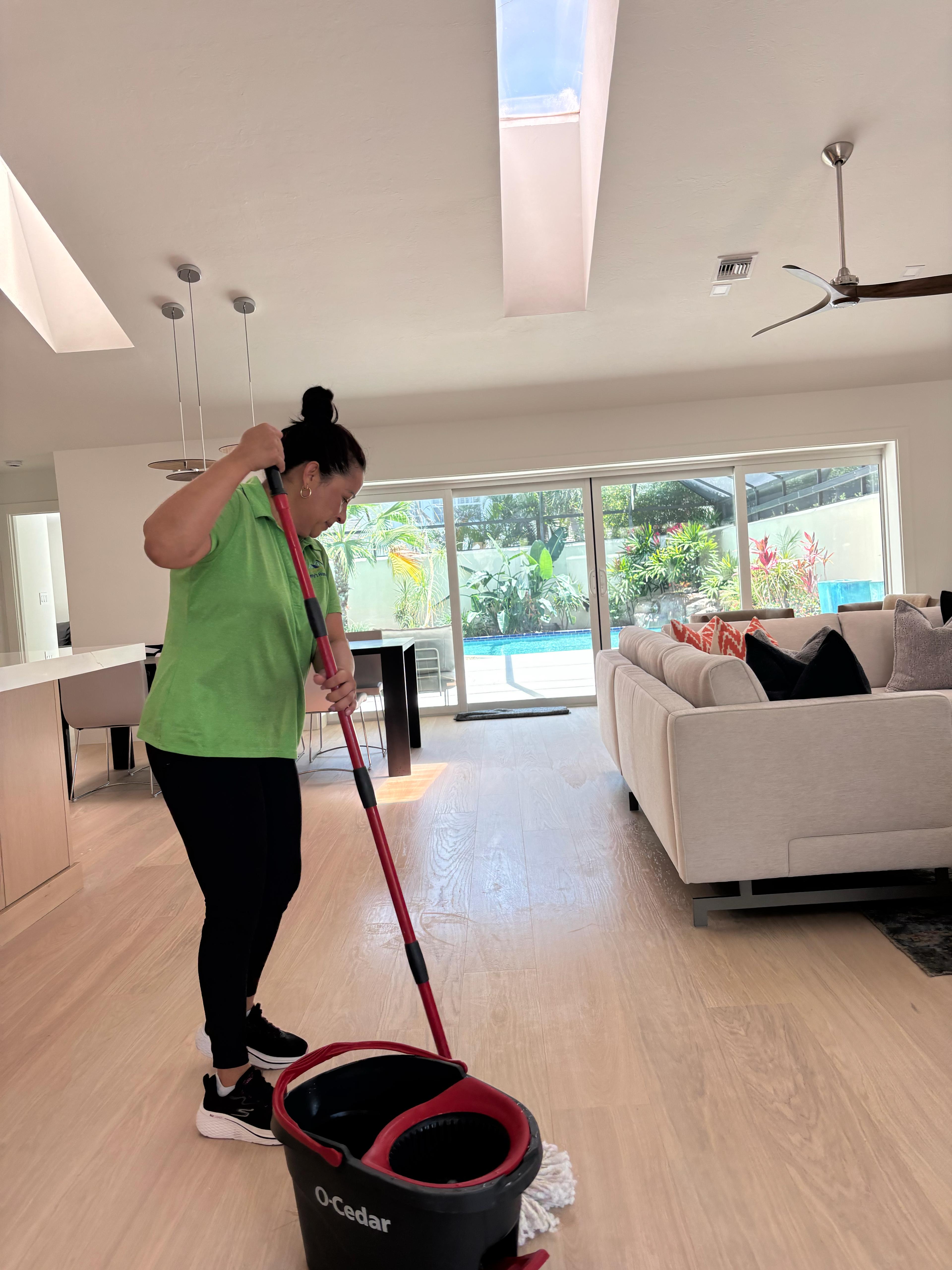 Delmy's Home Services team member mopping floors in a Naples Park home, Naples FL 34108